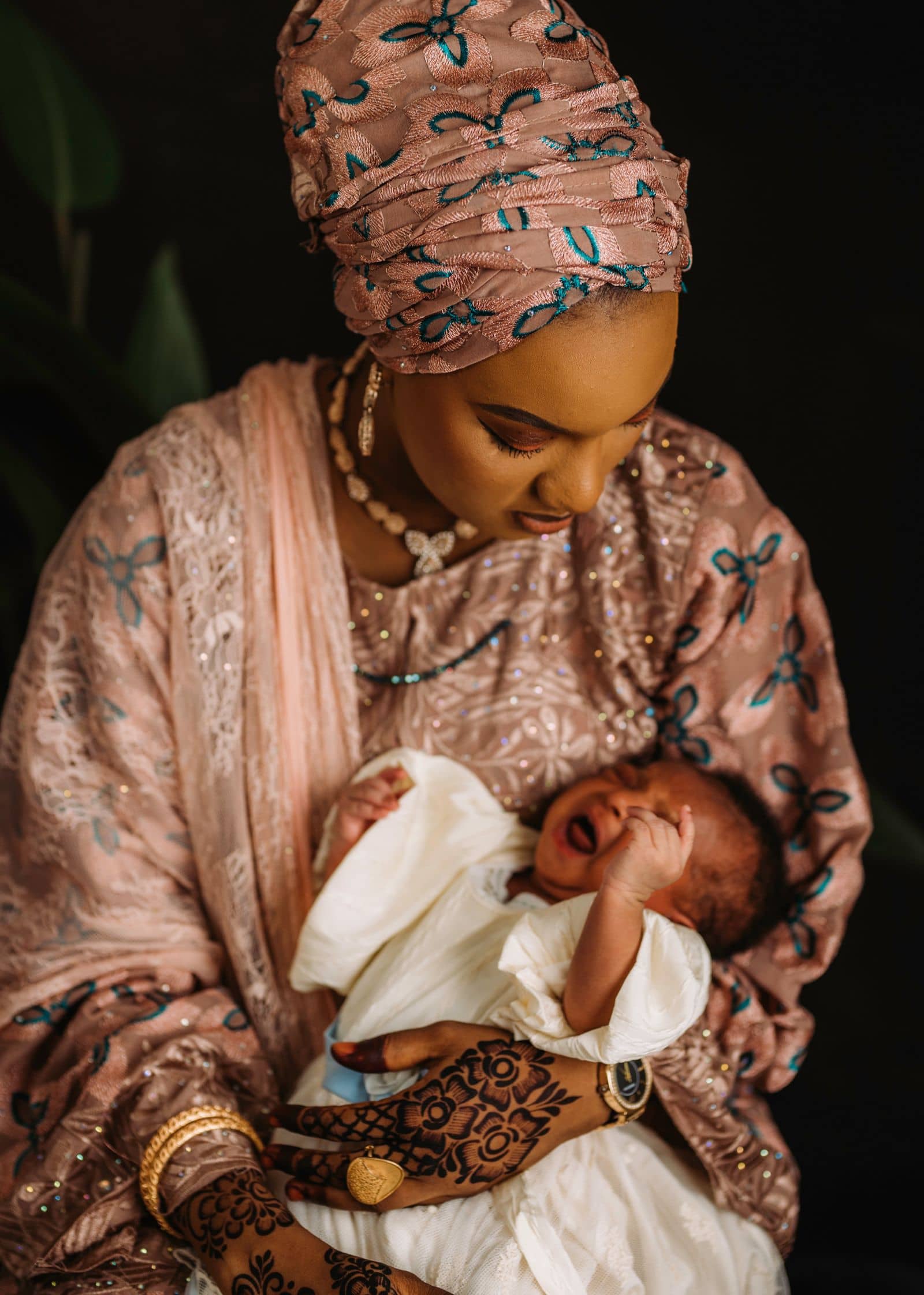 Mother in a gele holding her newborn